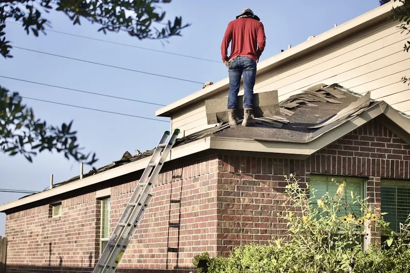 Professional roofer working on a residential roof in Power Ranch